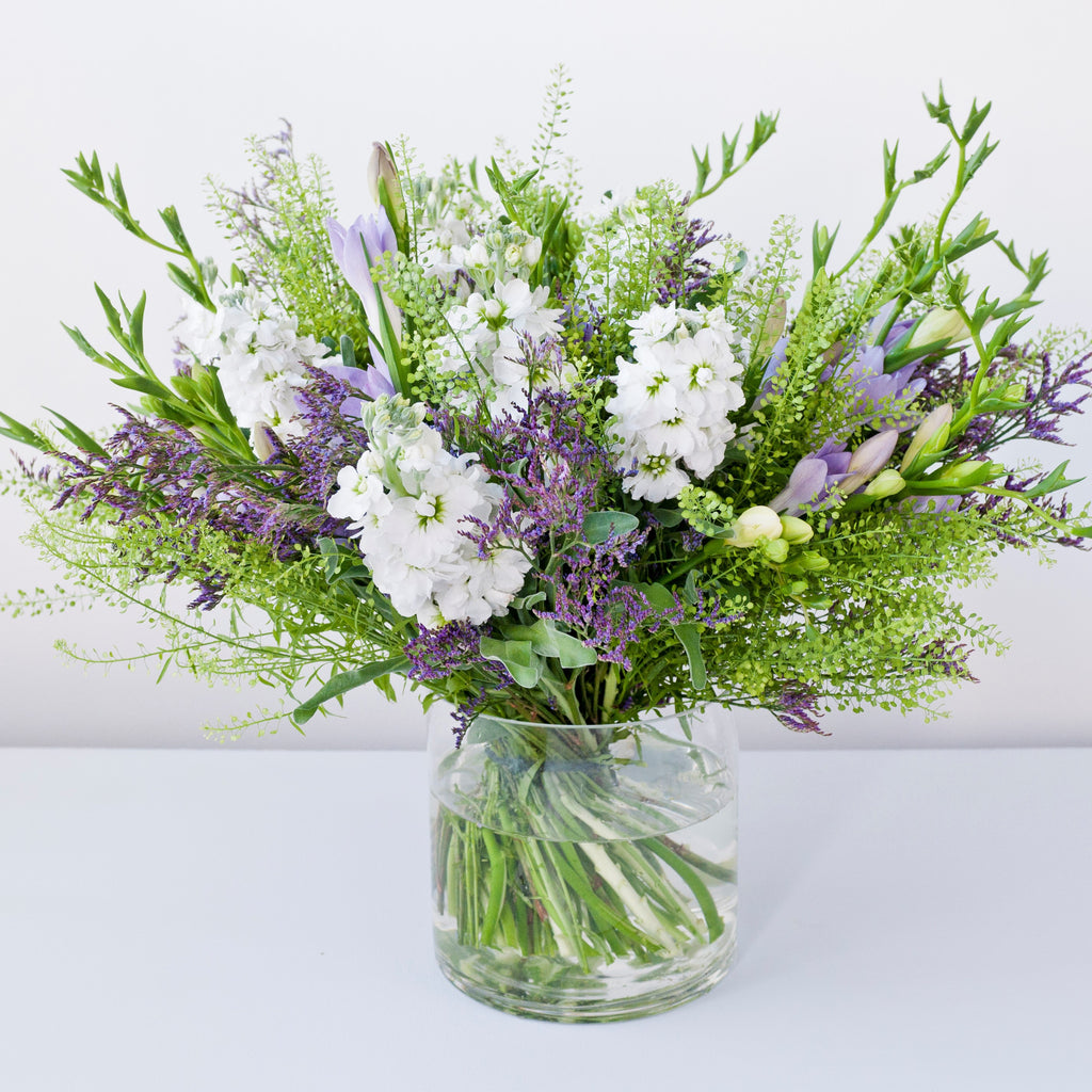 Image of lilac freesias, white stock, purple statice, foliage in a vase - Sherree Francis Flowers  