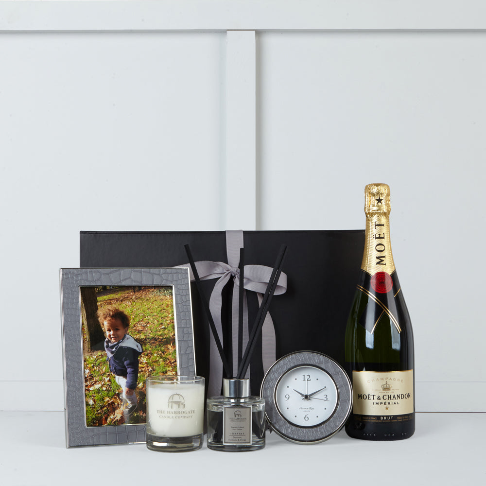 Image of faux crocodile clock & photo frame by Addison Ross. scented candle & diffuser by The Harrogate Candle Company & Moet et Chandon champagne